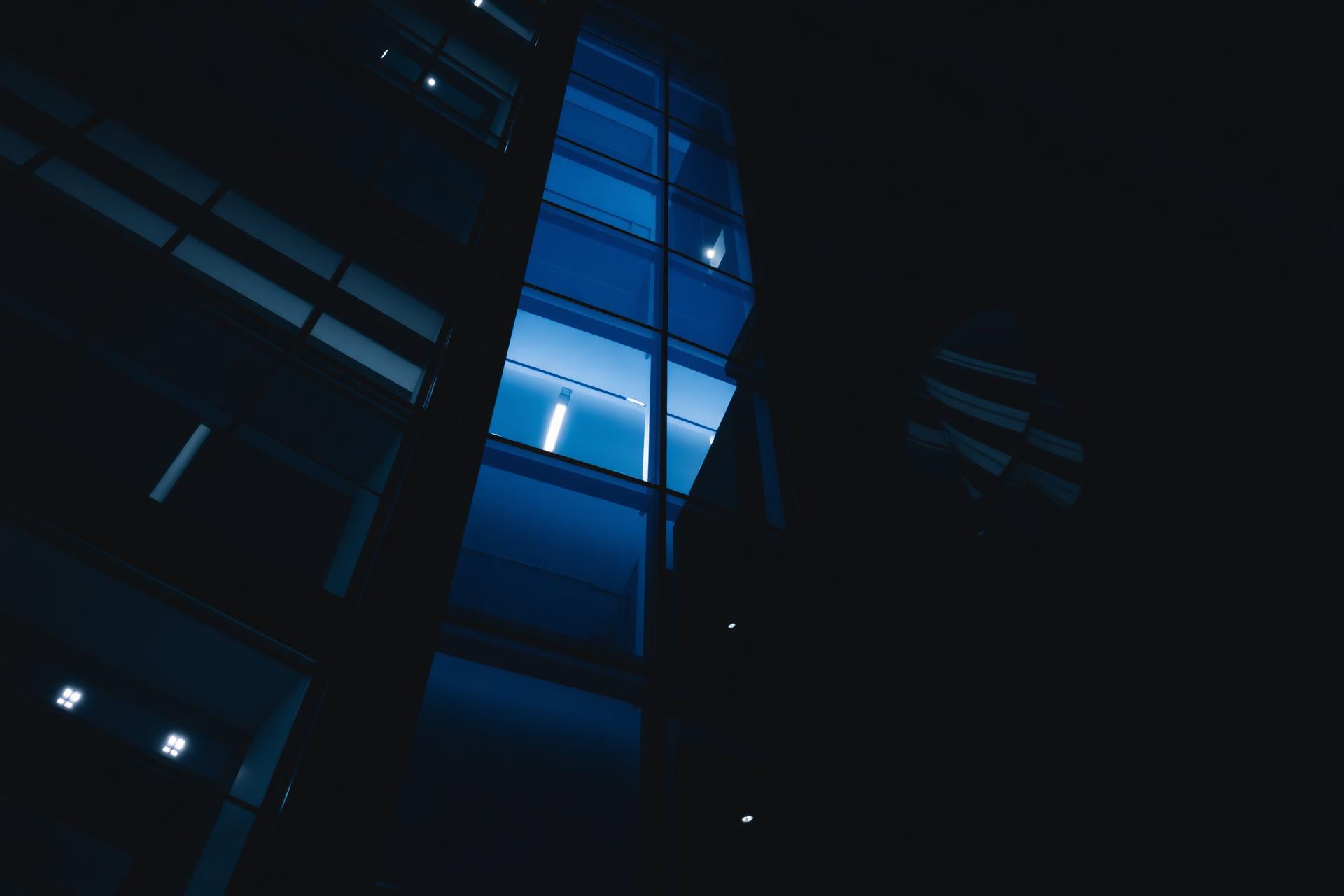 Modern glass office tower at twilight
